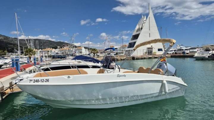 Cayman 585 charter bareboat or captained in  Cala Galdana
